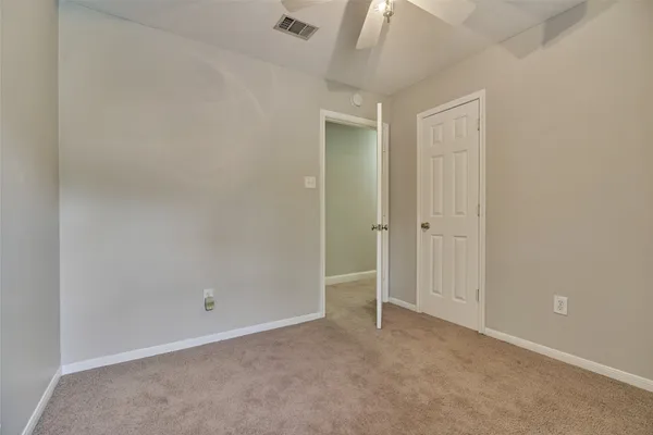 an empty room with closet area
