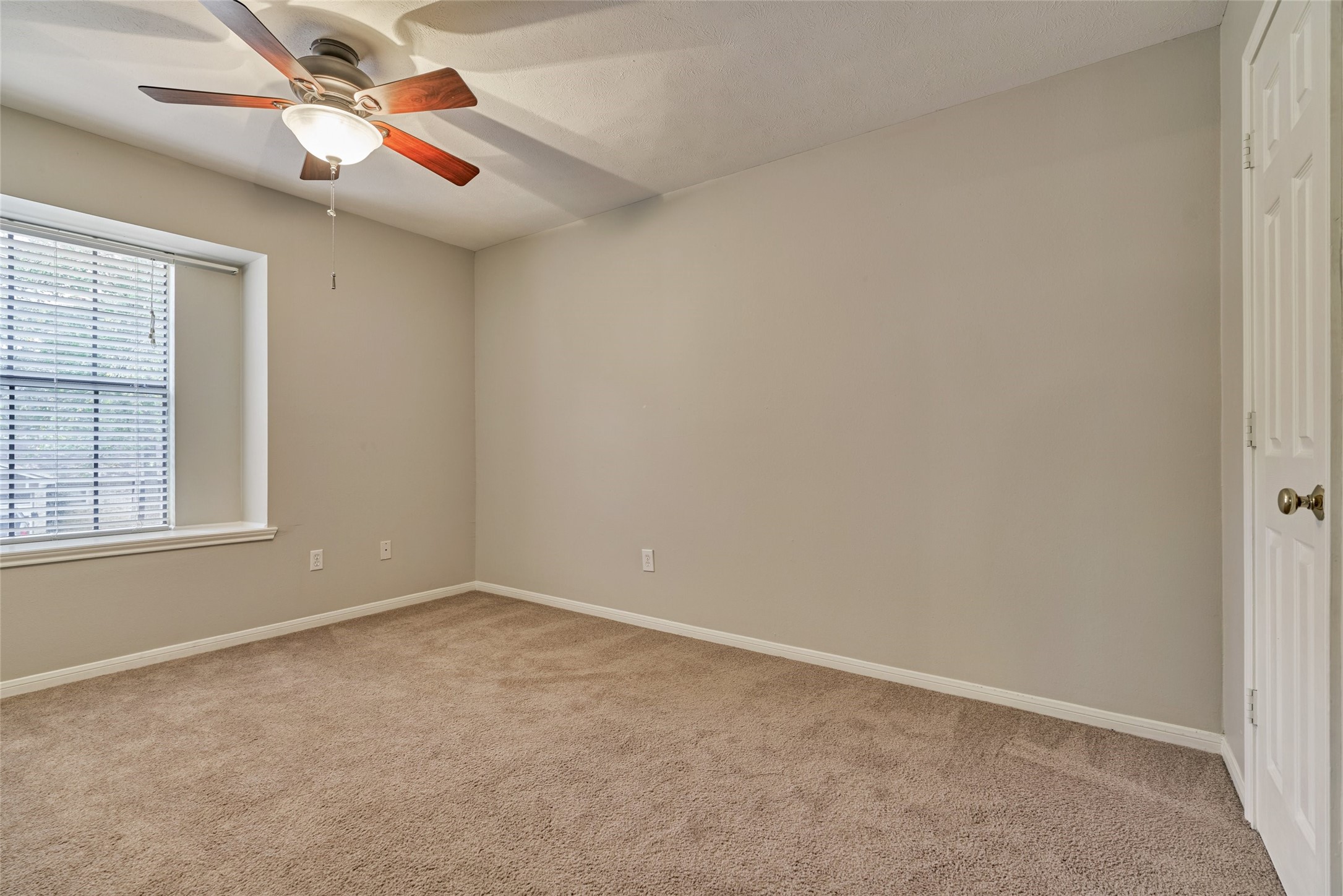 3 Field Flower Court Spring, TX 77380 - Photo 28 of 36 an empty room with windows and fan