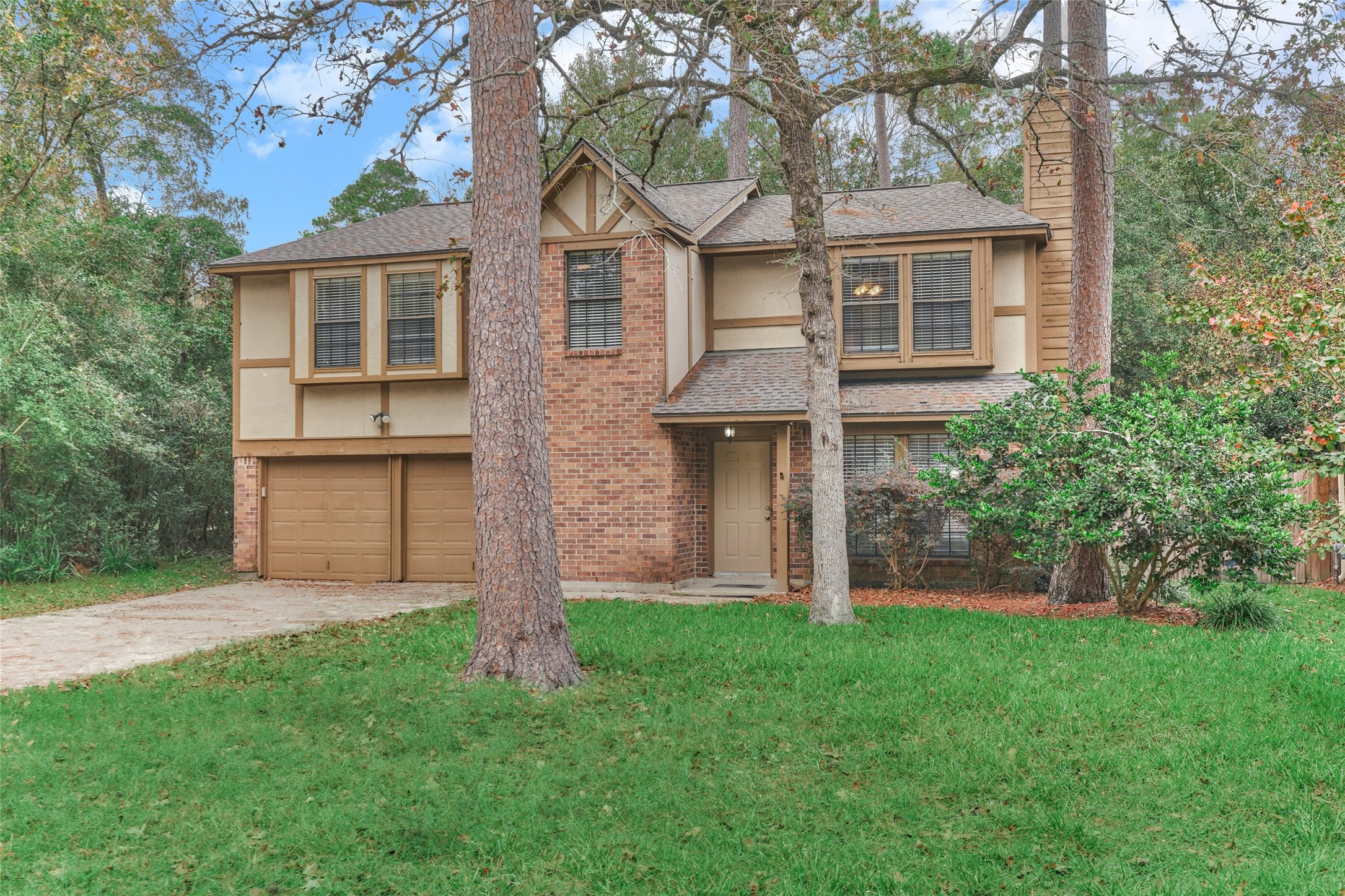 3 Field Flower Court Spring, TX 77380 - Photo 3 of 36 a view of a brick house with a yard and large tree