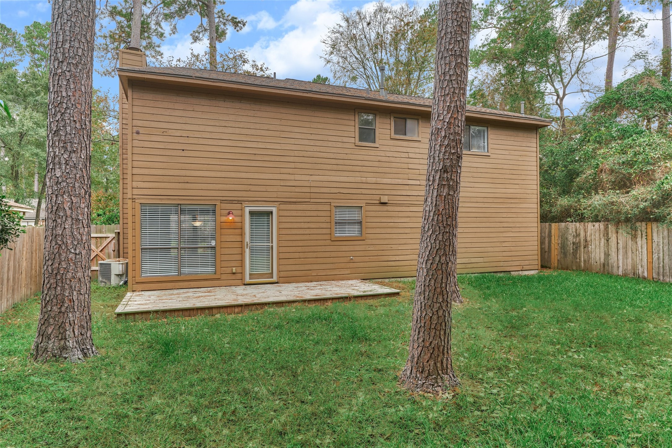 3 Field Flower Court Spring, TX 77380 - Photo 33 of 36 a view of a backyard with wooden fence