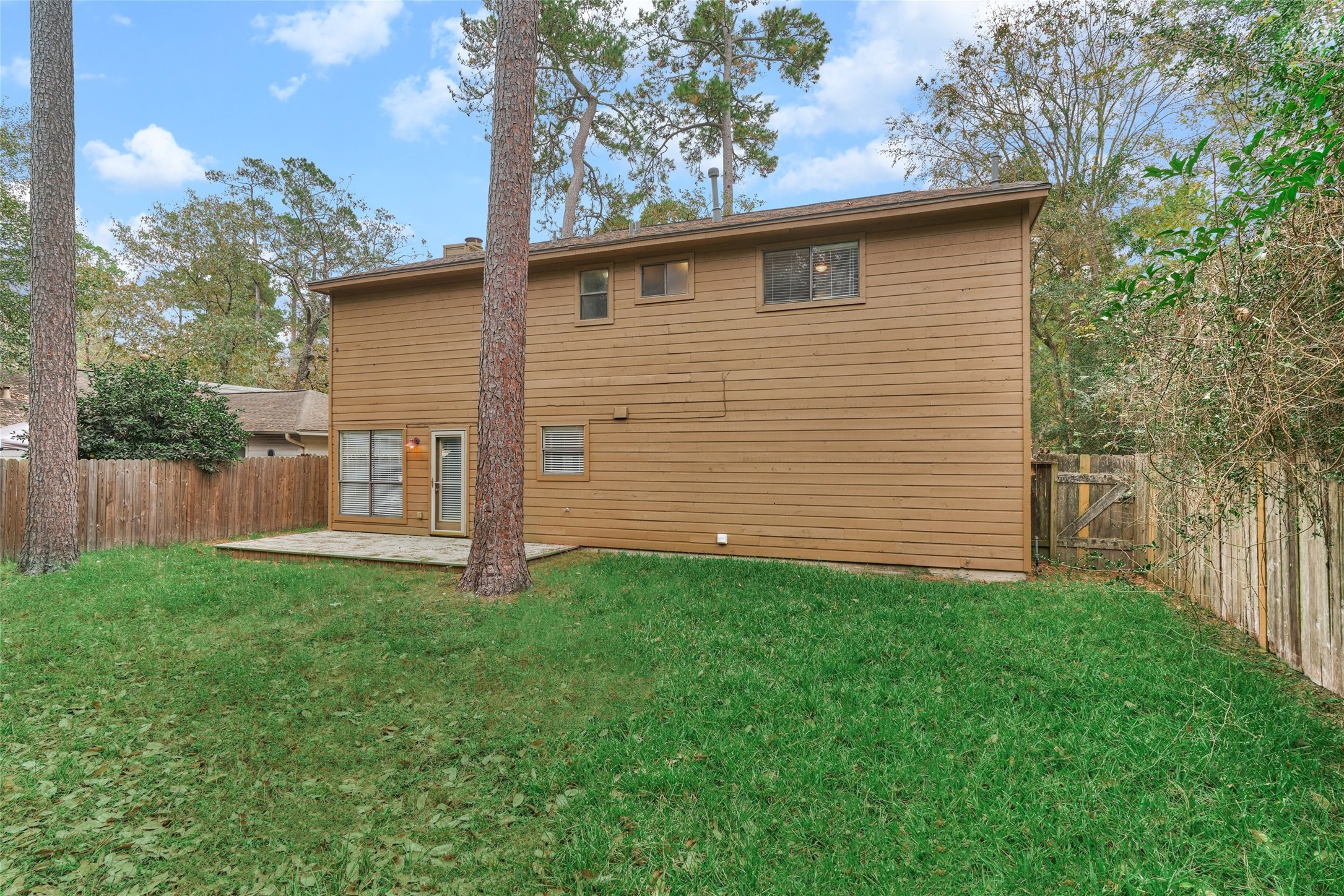 3 Field Flower Court Spring, TX 77380 - Photo 34 of 36 a view of a backyard with barn plants and large tree