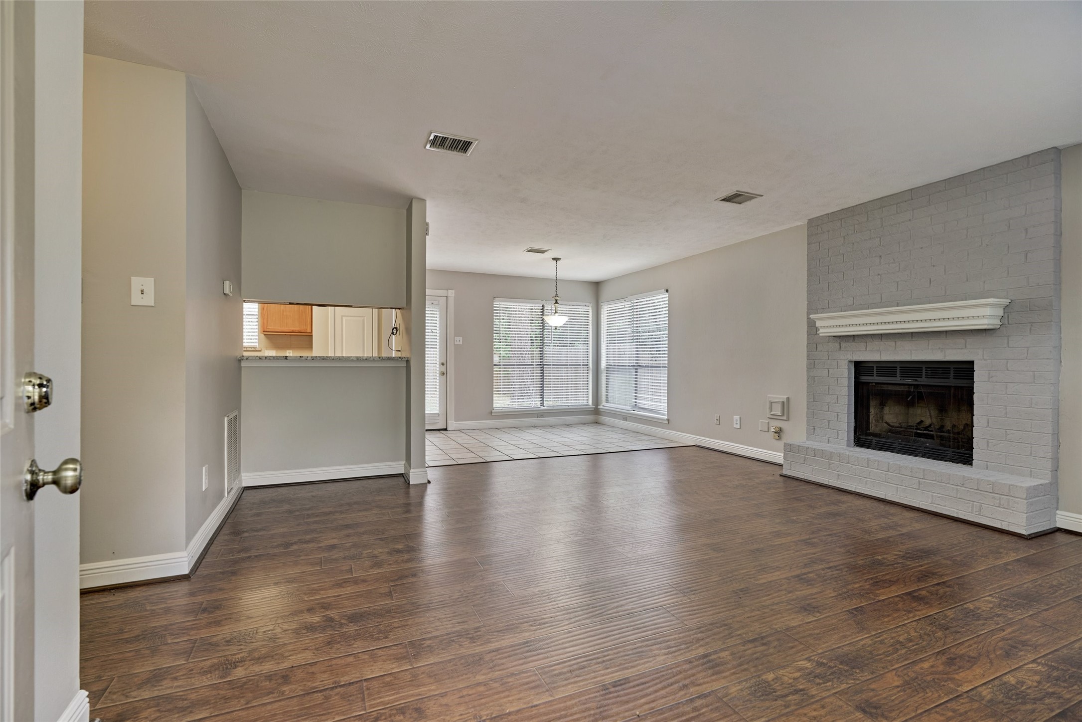3 Field Flower Court Spring, TX 77380 - Photo 7 of 36 a view of empty room with wooden floor and fireplace