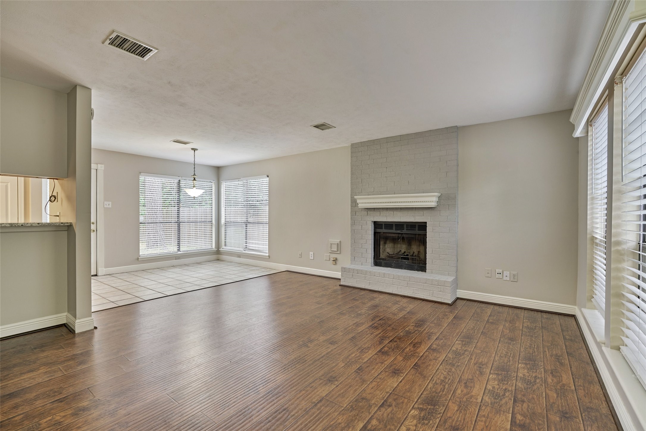 3 Field Flower Court Spring, TX 77380 - Photo 8 of 36 an empty room with wooden floor and fireplace