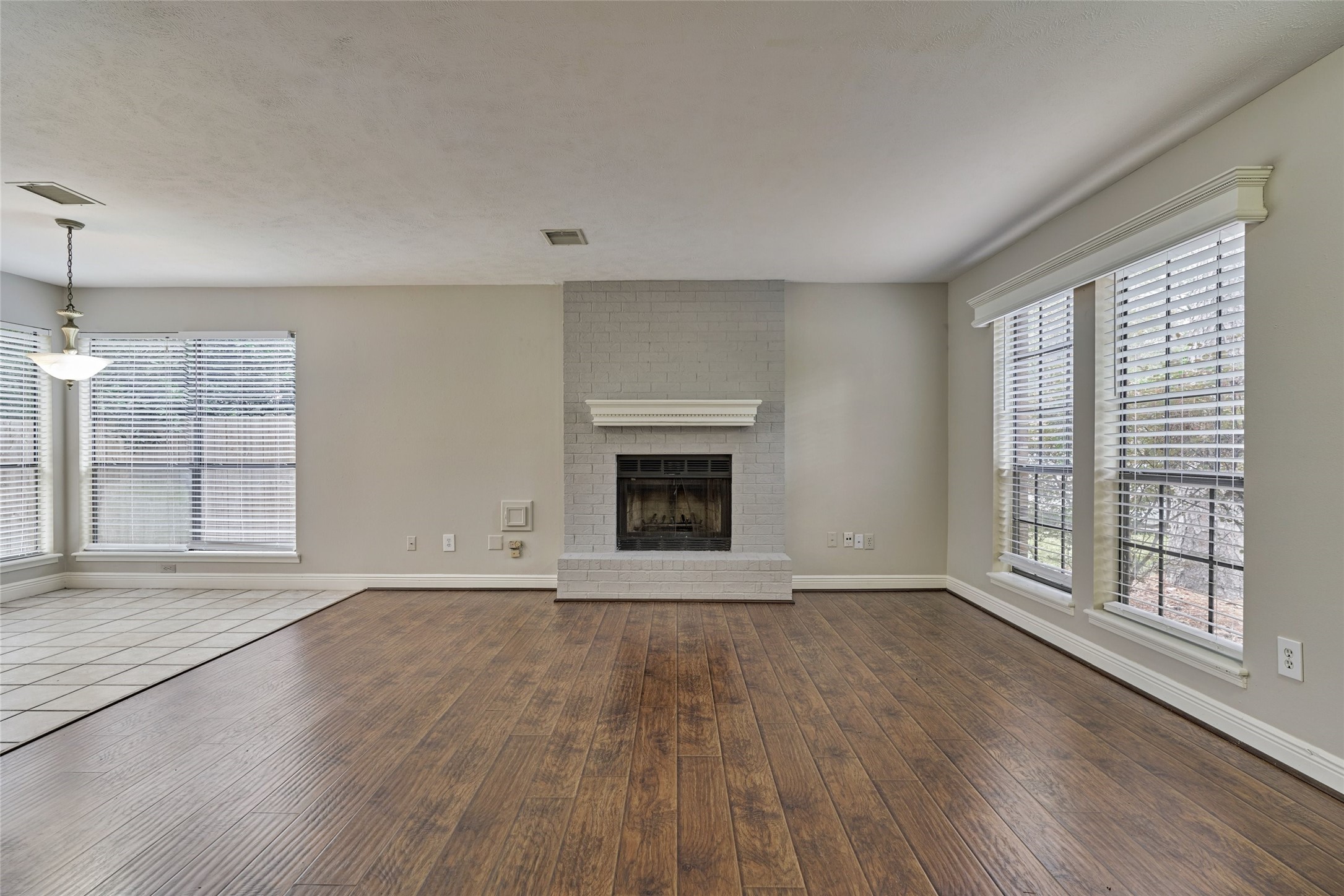 3 Field Flower Court Spring, TX 77380 - Photo 9 of 36 a view of an empty room with wooden floor and a window