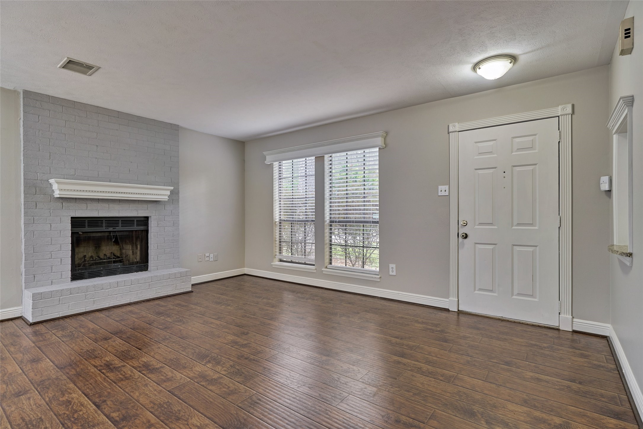 3 Field Flower Court Spring, TX 77380 - Photo 10 of 36 wooden floor fireplace and windows in an empty room