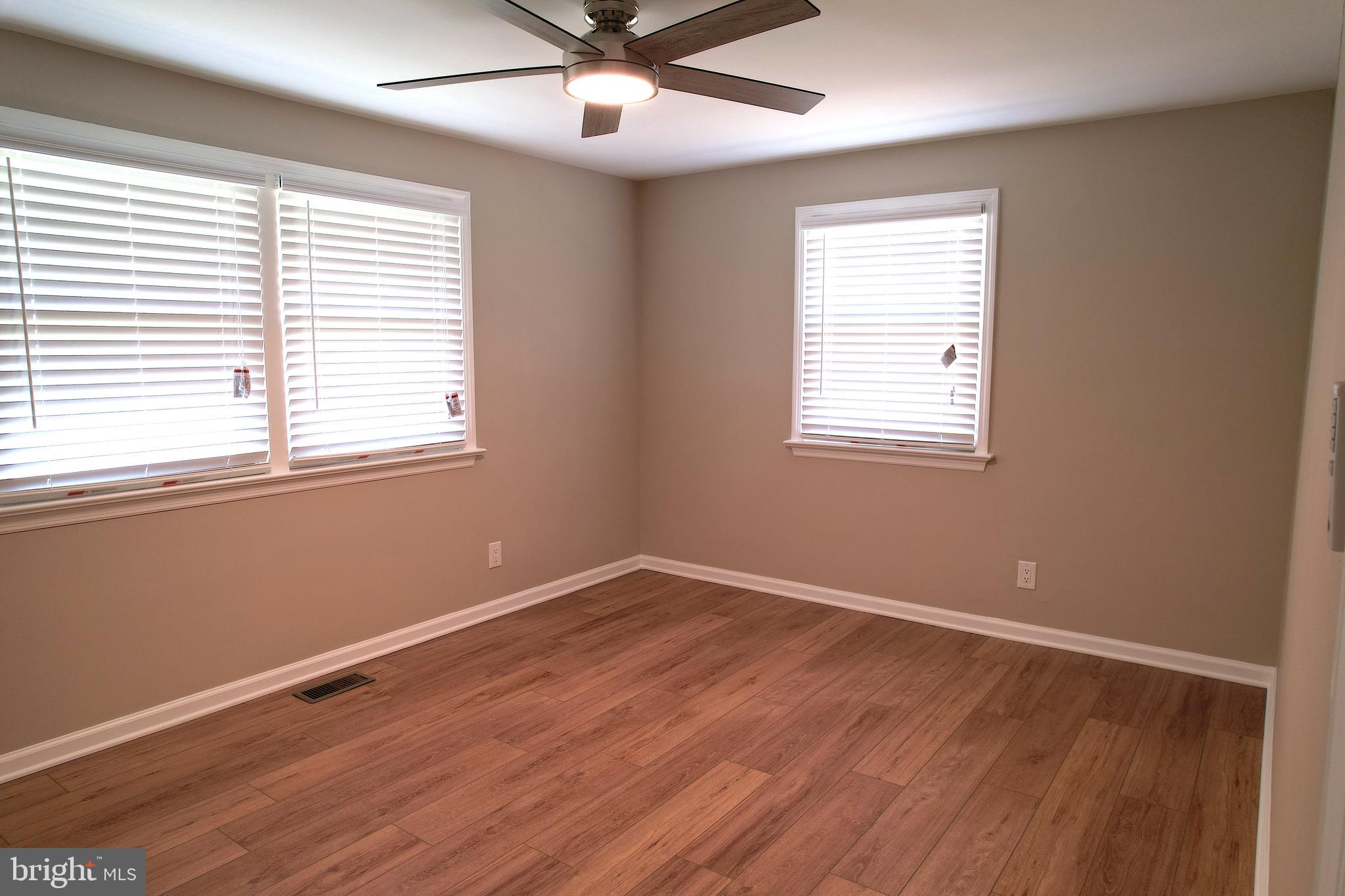 555 Fairview Road Glassboro, NJ 08028 - Photo 23 of 46 a view of an empty room with wooden floor and a window