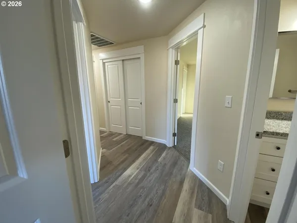 a view of a hallway with wooden floor