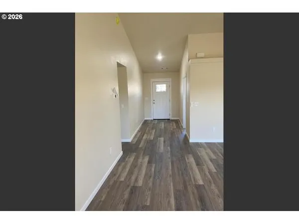 a view of hallway with wooden floor