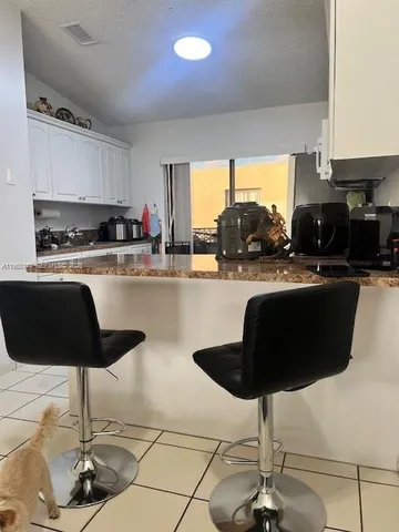 a kitchen with stainless steel appliances kitchen island granite countertop a sink and cabinets