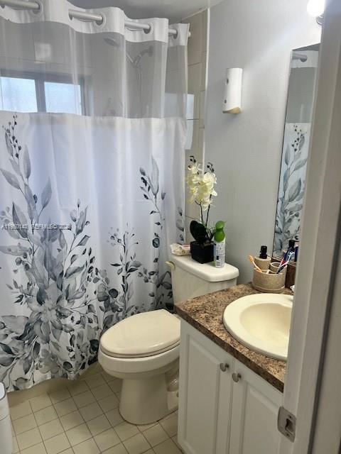 2815 West 76th Street, Unit 20217 Hialeah, FL 33018 - Photo 8 of 10 a bathroom with a granite countertop sink toilet and a mirror