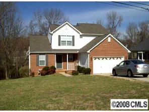 5123 Cheviot Road Charlotte, NC 28269 - Photo 1 of 7 a front view of a house with a yard