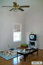 5123 Cheviot Road Charlotte, NC 28269 - Photo 2 of 7 a living room with kitchen furniture and a wooden floor