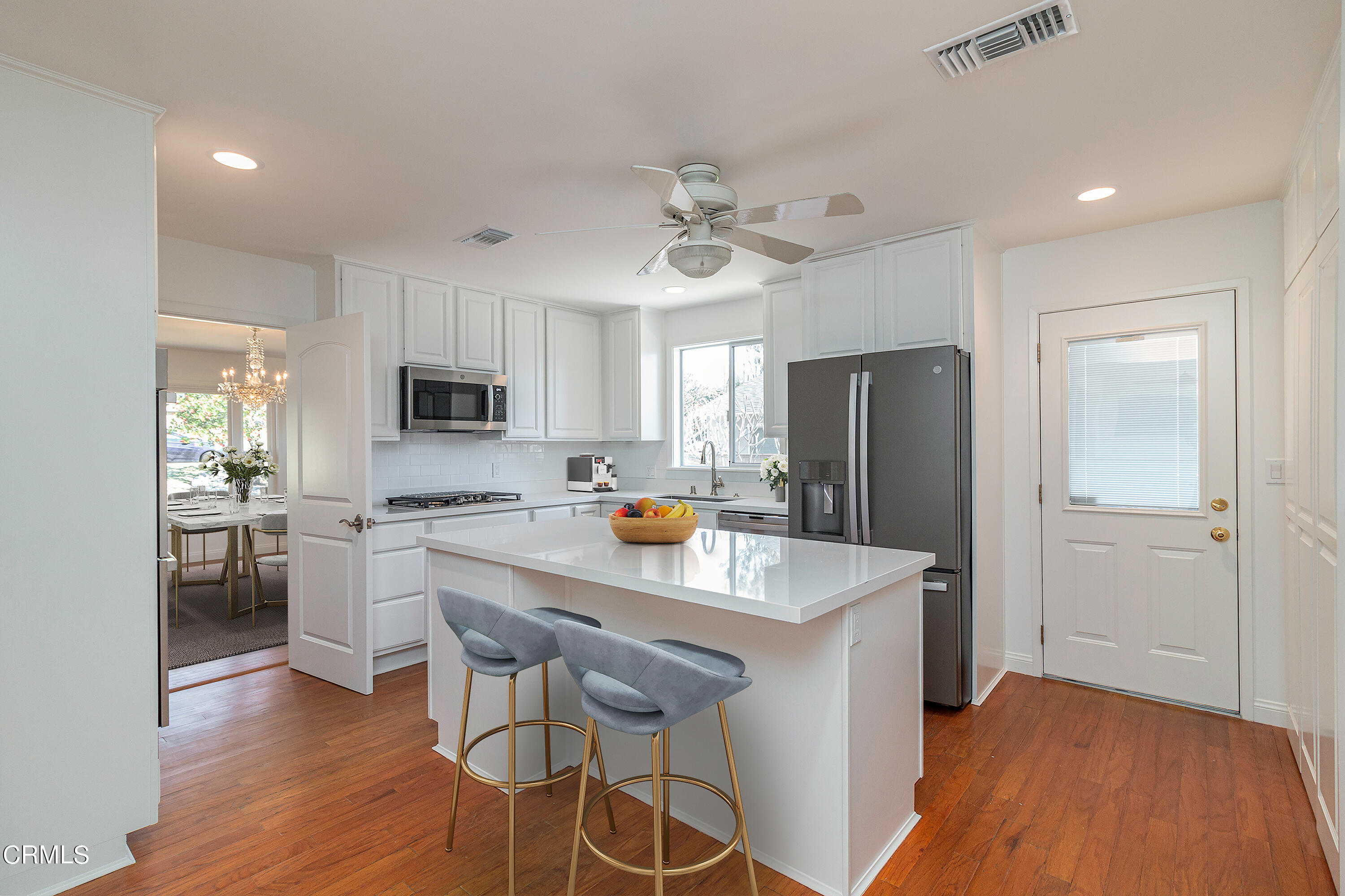 3850 Shadow Grove Road Pasadena, CA 91107 - Photo 4 of 16 a kitchen with stainless steel appliances a sink a stove a refrigerator cabinets and chairs