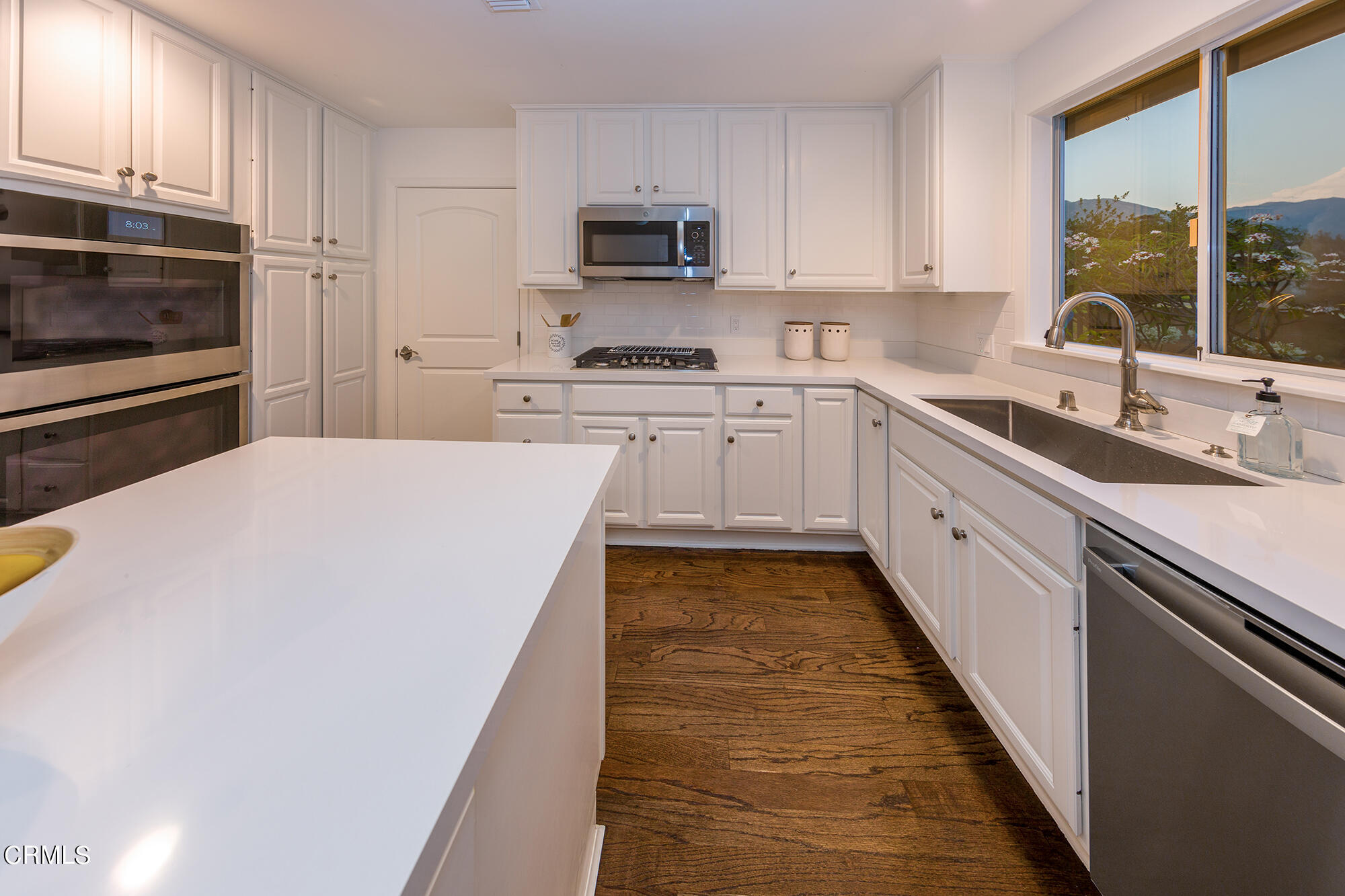 3850 Shadow Grove Road Pasadena, CA 91107 - Photo 5 of 16 a kitchen with stainless steel appliances a stove sink microwave and cabinets