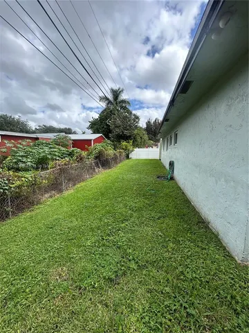 a view of a yard with an outdoor seating