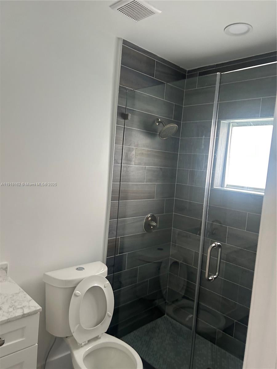 6121 Southwest 48th Court, Unit 3 Davie, FL 33314 - Photo 6 of 14 a bathroom with a toilet and a shower