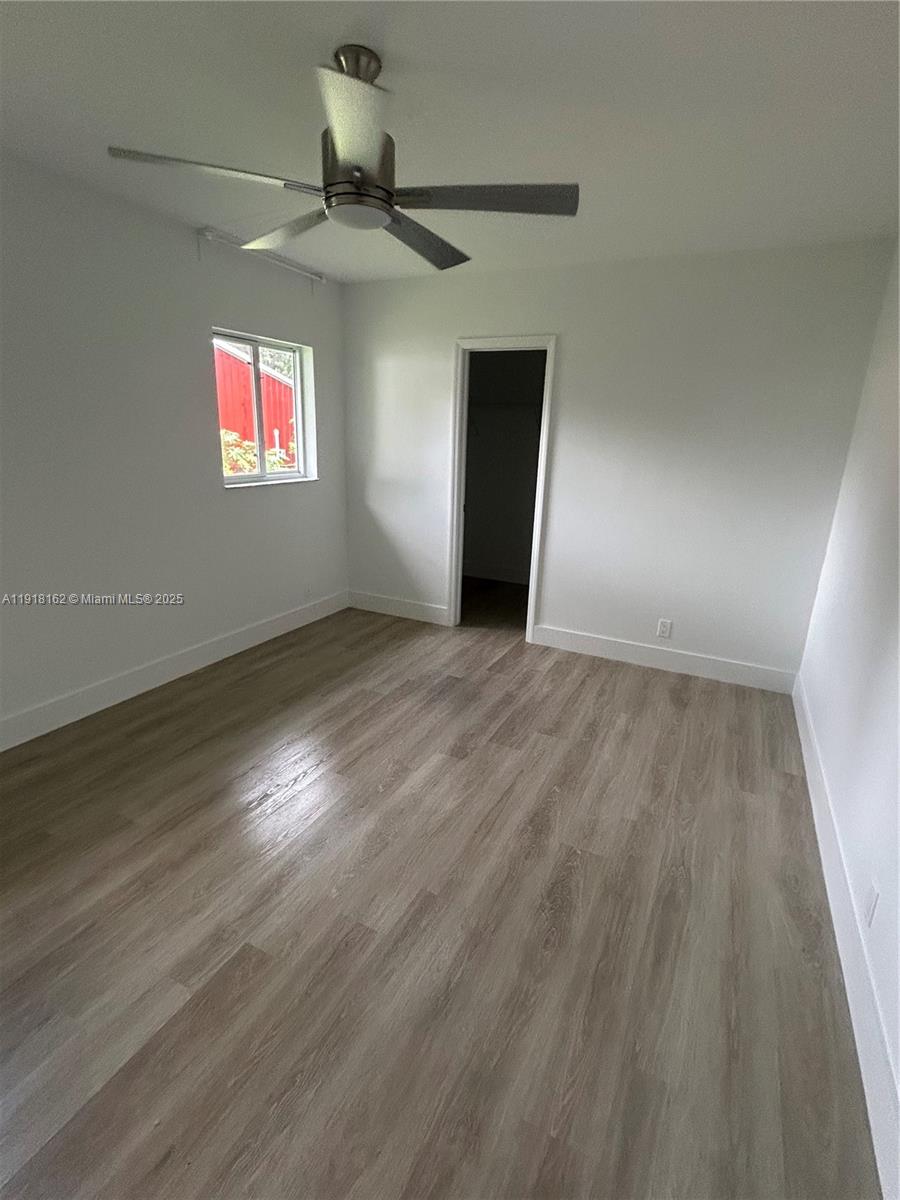 6121 Southwest 48th Court, Unit 3 Davie, FL 33314 - Photo 8 of 14 an empty room with wooden floor closet and windows