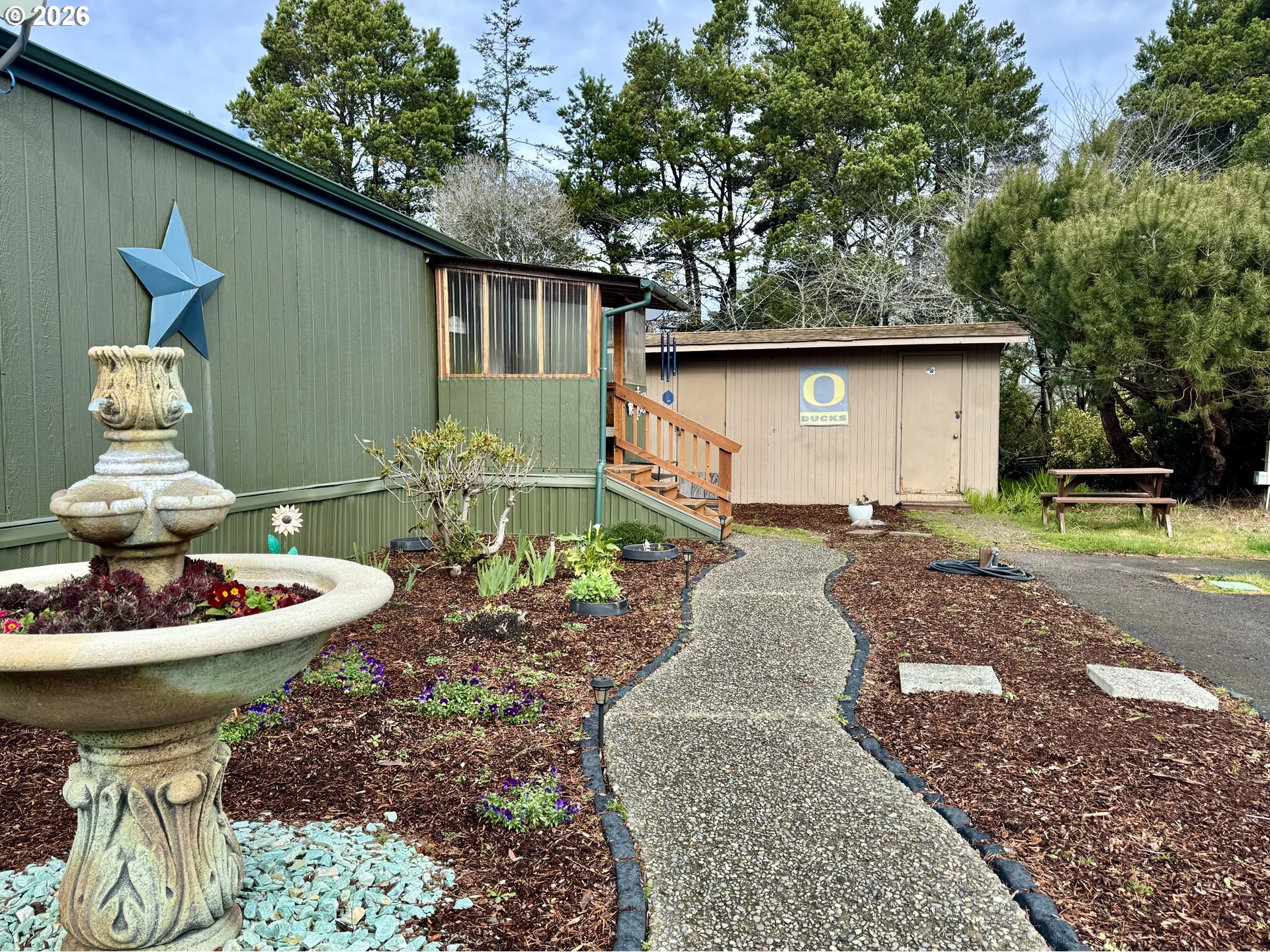 3760 Highway 101, Unit 1 Florence, OR 97439 - Photo 2 of 32 a front view of a house with garden