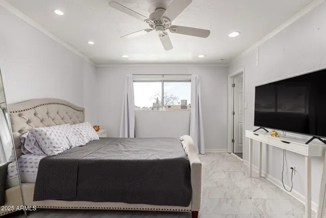 a bedroom with a bed and a flat screen tv