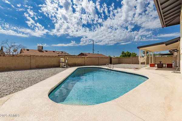 a view of a swimming pool with a yard