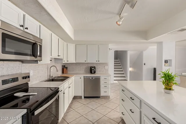 a kitchen with a sink stove and microwave