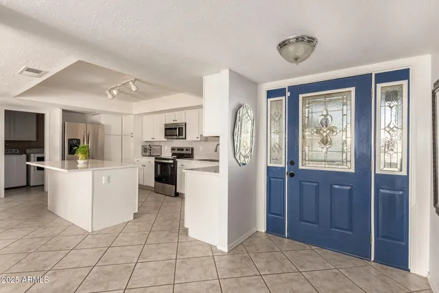 a kitchen with cabinets and refrigerator