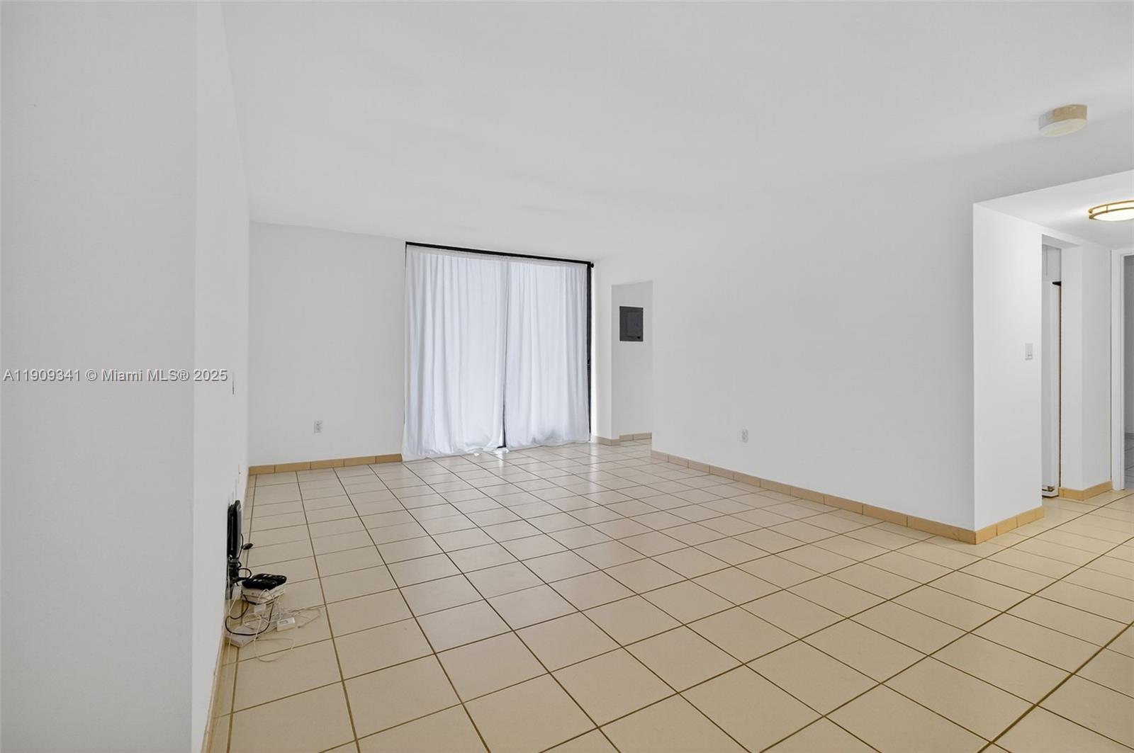 6061 Collins Avenue, Unit 7B Miami Beach, FL 33140 - Photo 12 of 41 a view of an empty room and wooden floor