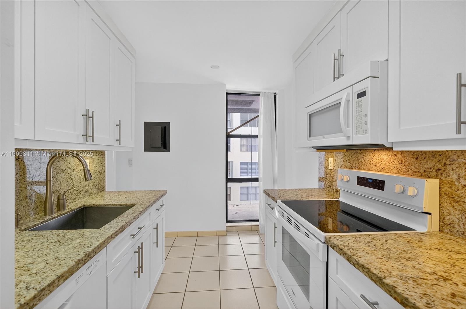 6061 Collins Avenue, Unit 7B Miami Beach, FL 33140 - Photo 23 of 41 a kitchen with stainless steel appliances granite countertop a sink stove and refrigerator