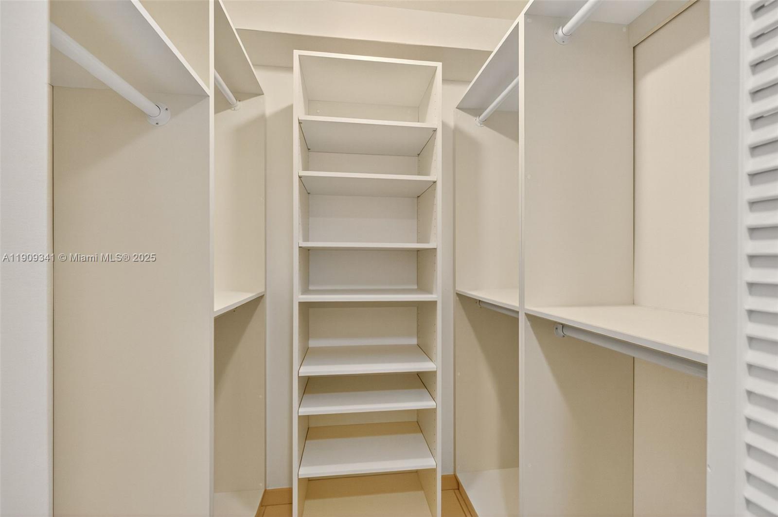 6061 Collins Avenue, Unit 7B Miami Beach, FL 33140 - Photo 26 of 41 a view of walk in closet with empty racks