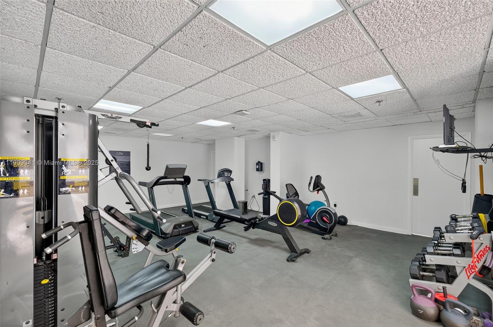 6061 Collins Avenue, Unit 7B Miami Beach, FL 33140 - Photo 27 of 41 a view of a room with gym equipment