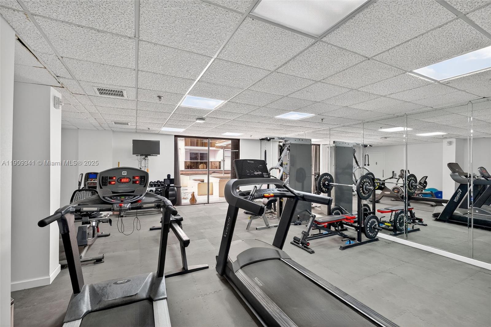 6061 Collins Avenue, Unit 7B Miami Beach, FL 33140 - Photo 28 of 41 a view of a room with gym equipment