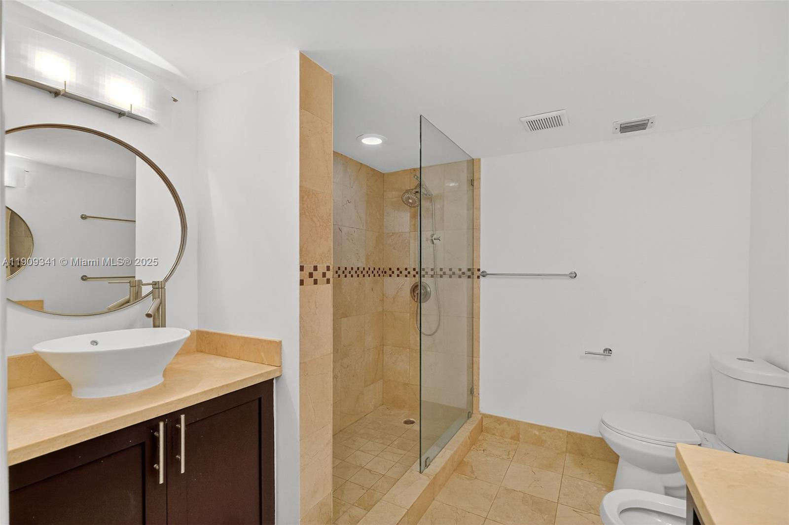 6061 Collins Avenue, Unit 7B Miami Beach, FL 33140 - Photo 35 of 41 a bathroom with a sink a toilet and shower