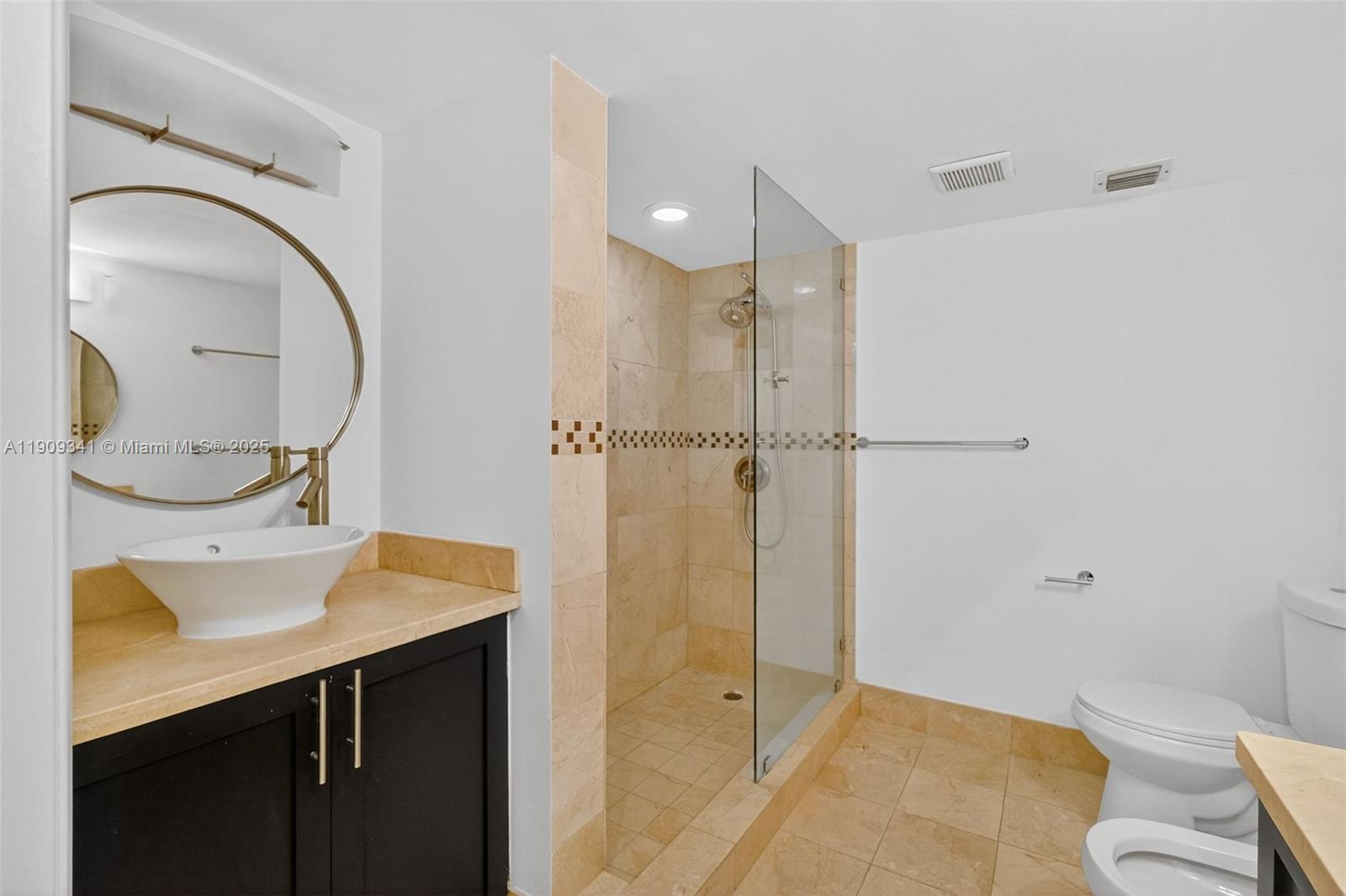 6061 Collins Avenue, Unit 7B Miami Beach, FL 33140 - Photo 38 of 41 a bathroom with a sink a toilet and shower