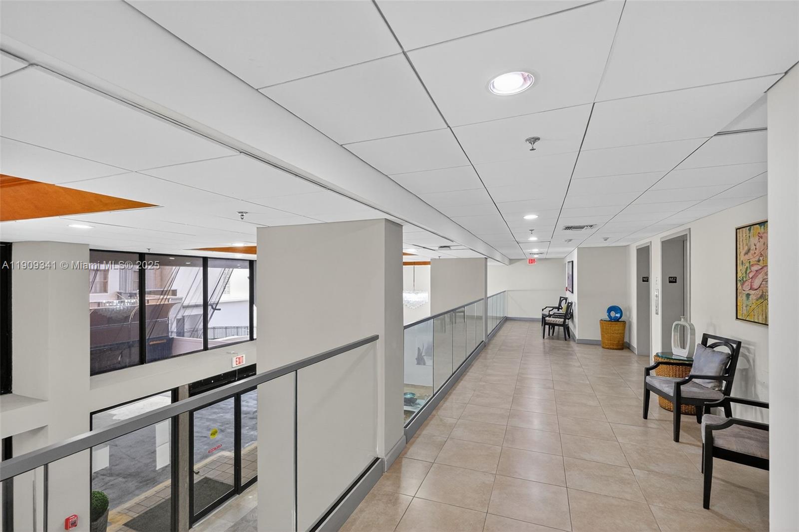 6061 Collins Avenue, Unit 7B Miami Beach, FL 33140 - Photo 8 of 41 a view of a hallway with the couches and dining table chairs