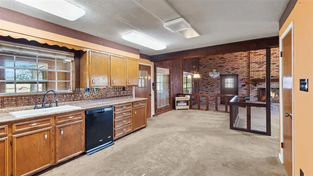 a view of a big room with windows and chandelier fan