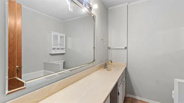 a bathroom with a tub sink and mirror