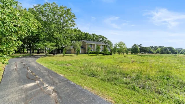 an aerial view of a houses with a lake view