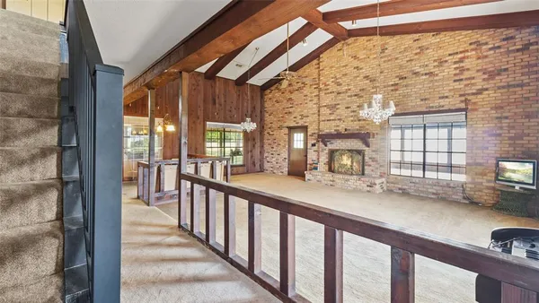 a view of a porch with wooden floor and furniture