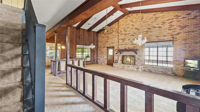 a view of a porch with wooden floor and furniture