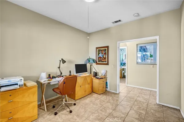 a living room with furniture a rug and a wall painting