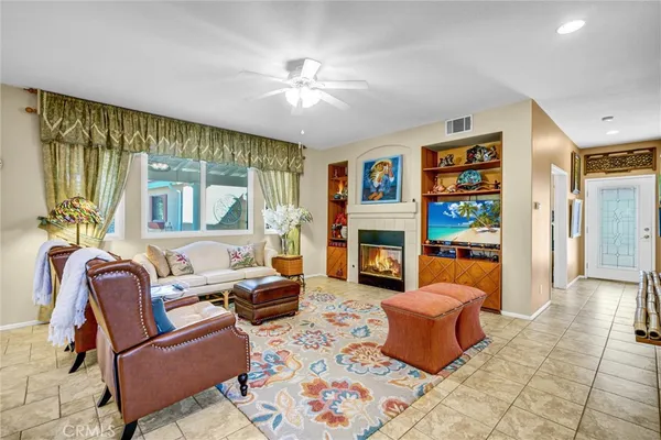 a dining room with furniture a chandelier and wooden floor