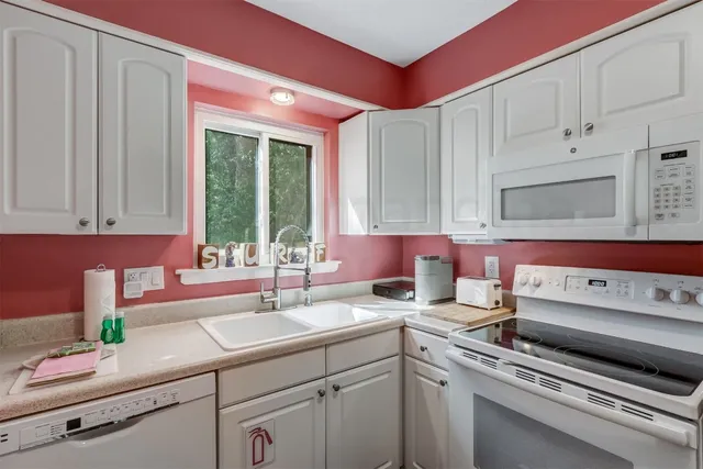 a kitchen with a sink cabinets and window