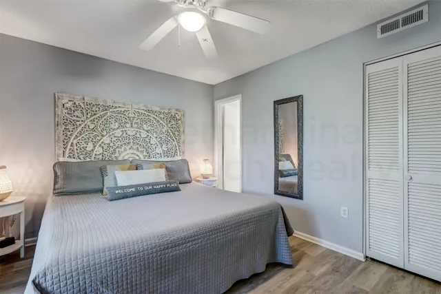 a bedroom with a bed and a painting