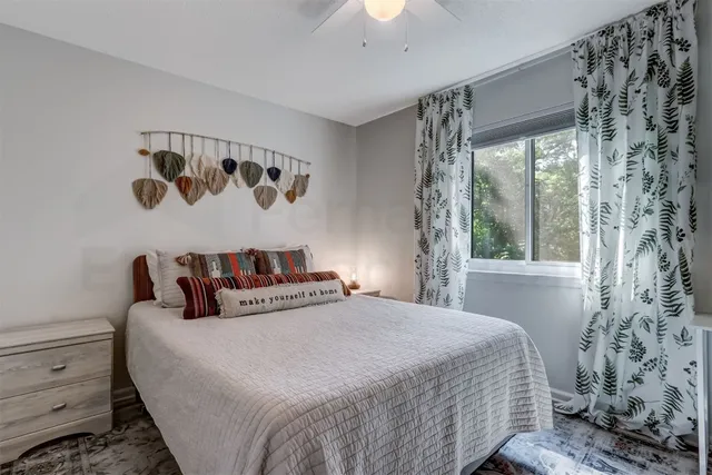 a bedroom with a large bed and a window