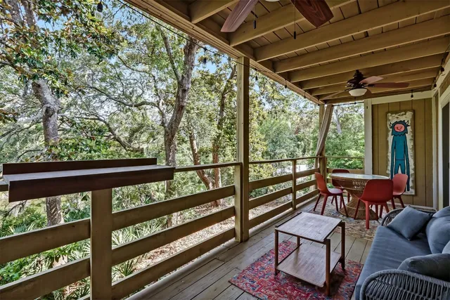 a view of a chairs and table in the balcony