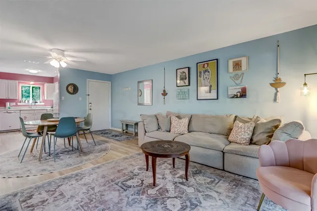 a living room with furniture and wooden floor
