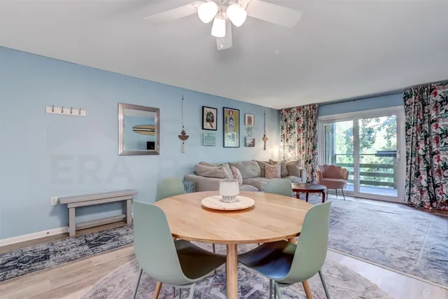 a view of a dining room with furniture window and wooden floor