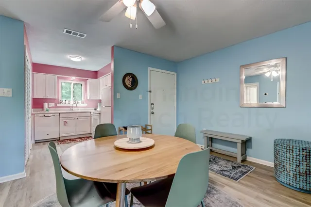 a view of a dining room with furniture and wooden floor