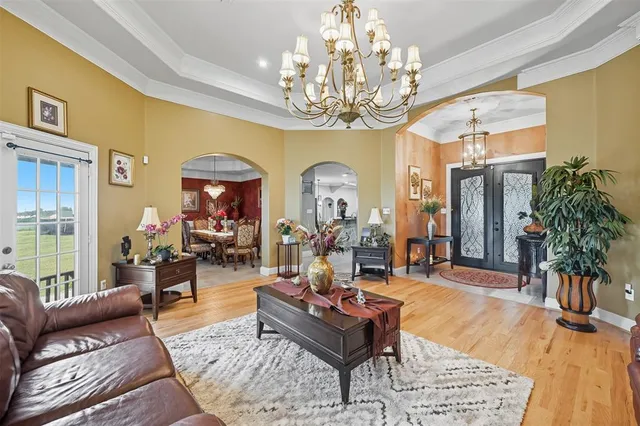 a living room with furniture and a chandelier