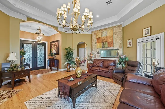 a living room with furniture chandelier and a chandelier